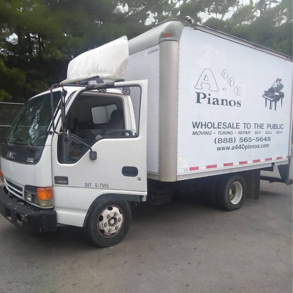 A440 piano movers carefully transporting a grand piano