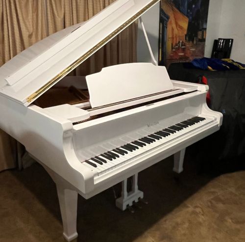 White grand piano after delivery